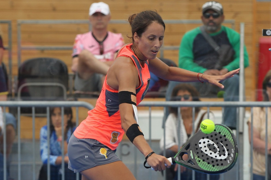 Padel player at full stretch mid volley