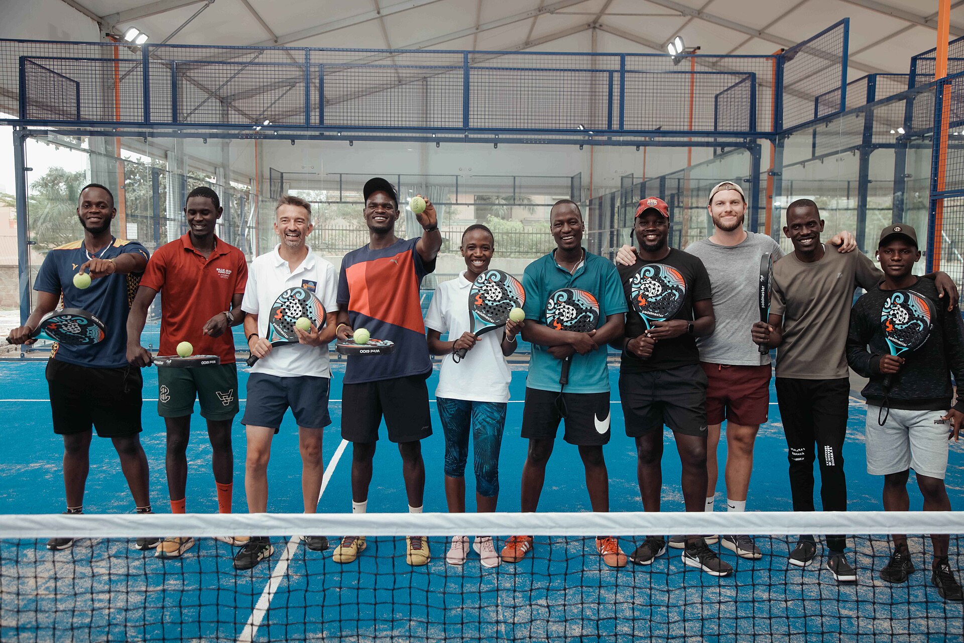 Players lined up on court in matching tournament shirts